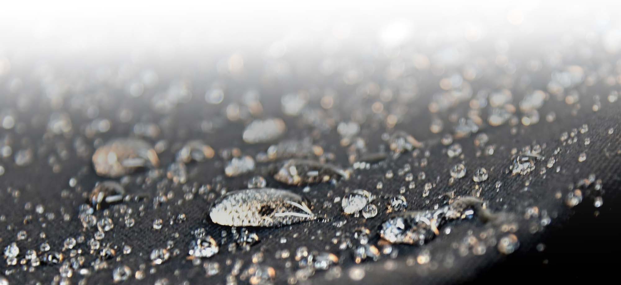 Water sitting on black material